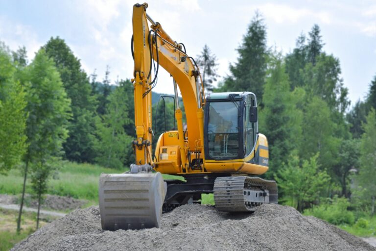 excavator on dirt mound